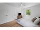 Bright bedroom with neutral decor, ceiling fan, hardwood floors, and large window at 2238 Pinecliff Ne Dr, Atlanta, GA 30345