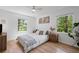 Cozy bedroom with natural light, featuring a ceiling fan, hardwood floors, and neutral decor at 2238 Pinecliff Ne Dr, Atlanta, GA 30345