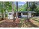 Charming renovated home with a light brick facade, modern wood accents, and mature trees at 2238 Pinecliff Ne Dr, Atlanta, GA 30345