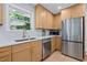 Modern kitchen featuring light wood cabinetry, stainless steel appliances, and quartz countertops with a backyard view at 2238 Pinecliff Ne Dr, Atlanta, GA 30345