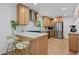 Modern kitchen features stainless steel appliances, light wood cabinets, and a breakfast bar with stylish seating at 2238 Pinecliff Ne Dr, Atlanta, GA 30345