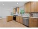 Modern kitchen with light wood cabinetry, stainless appliances, and quartz countertops open to the dining area at 2238 Pinecliff Ne Dr, Atlanta, GA 30345