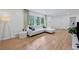 Bright living room featuring hardwood floors, a modern sectional sofa, and large windows for natural light at 2238 Pinecliff Ne Dr, Atlanta, GA 30345