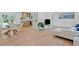 Bright living room featuring hardwood floors, a modern sectional sofa, a dining table, and an open view to the kitchen at 2238 Pinecliff Ne Dr, Atlanta, GA 30345