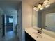 Hall bathroom featuring an extended vanity with white counter, a sink and large mirror at 3488 Woodshade Dr, Loganville, GA 30052