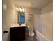 Bright bathroom featuring a modern vanity with dark wood cabinet and a shower-tub combination at 3488 Woodshade Dr, Loganville, GA 30052