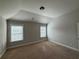 Bedroom with two windows allowing natural light, complemented by neutral paint and carpet at 3488 Woodshade Dr, Loganville, GA 30052