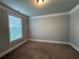 Bright bedroom with carpet flooring, neutral walls, and window providing natural light at 3488 Woodshade Dr, Loganville, GA 30052