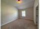 Bedroom with natural light, neutral paint and carpet, complemented by a ceiling light at 3488 Woodshade Dr, Loganville, GA 30052