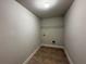 Empty walk in closet with brown vinyl flooring and a wire rack for storage and organization at 3488 Woodshade Dr, Loganville, GA 30052