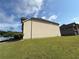 View of the side exterior featuring a lawn, beige siding and other nearby homes at 3488 Woodshade Dr, Loganville, GA 30052