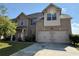 Charming two-story brick home with a well-manicured lawn and attached two-car garage at 3488 Woodshade Dr, Loganville, GA 30052