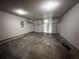 Spacious two-car garage with concrete flooring, white walls, and two garage doors at 3488 Woodshade Dr, Loganville, GA 30052