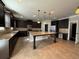 Spacious kitchen featuring granite countertops, dark cabinets, and stainless steel appliances at 3488 Woodshade Dr, Loganville, GA 30052
