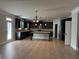 Large kitchen with dark cabinetry, granite countertops, a central island, and stainless steel appliances at 3488 Woodshade Dr, Loganville, GA 30052