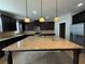 Kitchen island with granite countertops, dark cabinets, and stainless steel appliances at 3488 Woodshade Dr, Loganville, GA 30052
