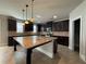 Kitchen island with granite countertops, dark cabinets, and stainless steel appliances at 3488 Woodshade Dr, Loganville, GA 30052