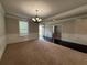 Elegant living room featuring crown molding, wainscotting, large windows, and dark wood flooring accents at 3488 Woodshade Dr, Loganville, GA 30052