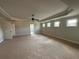 Spacious main bedroom with tray ceiling, ceiling fan, and lots of natural light at 3488 Woodshade Dr, Loganville, GA 30052