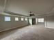 Spacious main bedroom with tray ceiling, ceiling fan, and lots of natural light at 3488 Woodshade Dr, Loganville, GA 30052