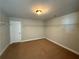 Spacious walk-in closet with carpet flooring, white door and plenty of shelving at 3488 Woodshade Dr, Loganville, GA 30052