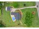 Aerial view of the property with pool, outbuilding, brick home, manicured lawn and mature trees, surrounded by landscaping at 4010 Hamilton Mill Rd, Buford, GA 30519