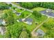 Aerial view of the property with pool, outbuilding, brick home, manicured lawn and mature trees, surrounded by a greenbelt at 4010 Hamilton Mill Rd, Buford, GA 30519