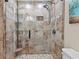 Walk-in shower featuring decorative tile, built-in shelves and seating in this renovated bathroom at 4010 Hamilton Mill Rd, Buford, GA 30519