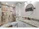 Renovated bathroom boasts a walk-in shower, granite countertop, and stylish fixtures at 4010 Hamilton Mill Rd, Buford, GA 30519