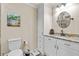 Bathroom features a vanity with granite countertop, storage cabinet, and decorative mirror at 4010 Hamilton Mill Rd, Buford, GA 30519