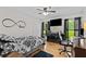 Bedroom features a ceiling fan, hardwood floors, a flat screen television, and closet at 4010 Hamilton Mill Rd, Buford, GA 30519