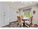 Bright breakfast nook features a glass table, stylish chairs and a large window with a view of the outdoors at 4010 Hamilton Mill Rd, Buford, GA 30519