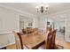 Formal dining room with wood floors, decorative light fixture, and easy access to other living areas at 4010 Hamilton Mill Rd, Buford, GA 30519