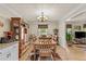 Traditional dining room boasts hardwood floors, large china cabinet, and stylish light fixture at 4010 Hamilton Mill Rd, Buford, GA 30519