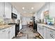 Well-lit kitchen featuring granite counters, stainless appliances, and white cabinets at 4010 Hamilton Mill Rd, Buford, GA 30519