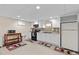Basement kitchenette with white cabinets, black appliances, and a mosaic backsplash at 4010 Hamilton Mill Rd, Buford, GA 30519