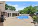 Backyard pool area with hot tub, lounge furniture and garden decor, surrounded by concrete patio at 4010 Hamilton Mill Rd, Buford, GA 30519