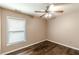 Cozy bedroom features hardwood floors, a ceiling fan, and a bright window at 5342 Lakerock Sw Dr, Atlanta, GA 30331
