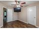 Well-lit bedroom with hardwood floors, ceiling fan, and access to other rooms at 5342 Lakerock Sw Dr, Atlanta, GA 30331