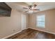 Comfortable bedroom showcasing hardwood floors, a ceiling fan, and a mounted television at 5342 Lakerock Sw Dr, Atlanta, GA 30331