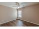 Bright bedroom featuring hardwood floors, a modern ceiling fan, and ample natural light at 5342 Lakerock Sw Dr, Atlanta, GA 30331