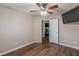 Large bedroom features hardwood floors, ceiling fan, and access to other rooms at 5342 Lakerock Sw Dr, Atlanta, GA 30331