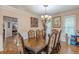 Dining room featuring a large wooden table with seating for eight under a decorative chandelier at 5342 Lakerock Sw Dr, Atlanta, GA 30331