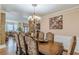 Elegant dining room featuring a large wooden table, decorative chairs, chandelier, and wall decor at 5342 Lakerock Sw Dr, Atlanta, GA 30331