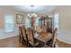 Bright dining room with large windows, a chandelier, and an elegant wooden table with ornate chairs at 5342 Lakerock Sw Dr, Atlanta, GA 30331