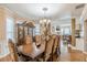 Spacious dining room with a large table, china cabinet, chandelier, and hardwood floors at 5342 Lakerock Sw Dr, Atlanta, GA 30331