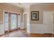 Welcoming foyer featuring a decorative glass front door, hardwood floors, and classic trim at 5342 Lakerock Sw Dr, Atlanta, GA 30331
