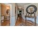 Inviting foyer with hardwood floors, elegant console table, and a decorative mirror at 5342 Lakerock Sw Dr, Atlanta, GA 30331