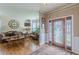 Elegant living room entrance with hardwood floors, sofa, and large bay window at 5342 Lakerock Sw Dr, Atlanta, GA 30331