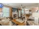 Open-concept living area showcasing fireplace, large windows and view to the kitchen at 5342 Lakerock Sw Dr, Atlanta, GA 30331